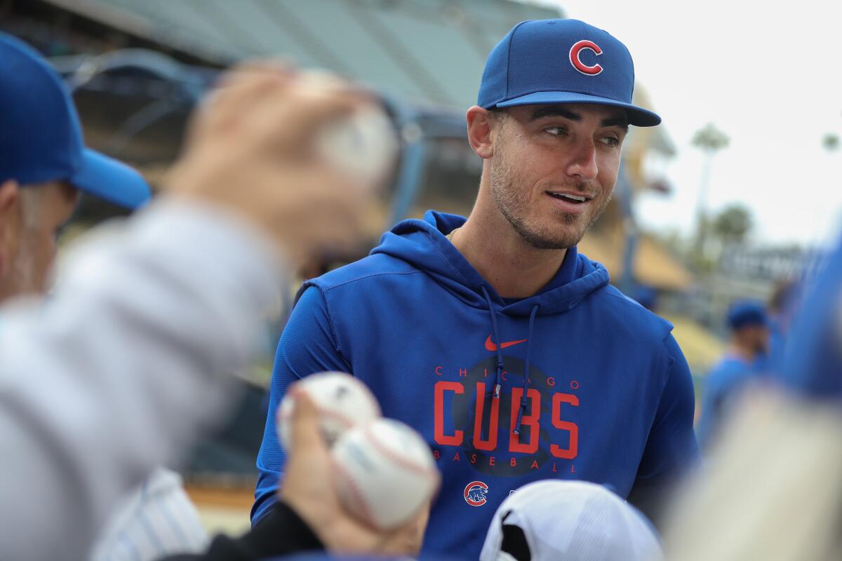 Cody Bellinger signs autographs for fans at Dodger Stadium.