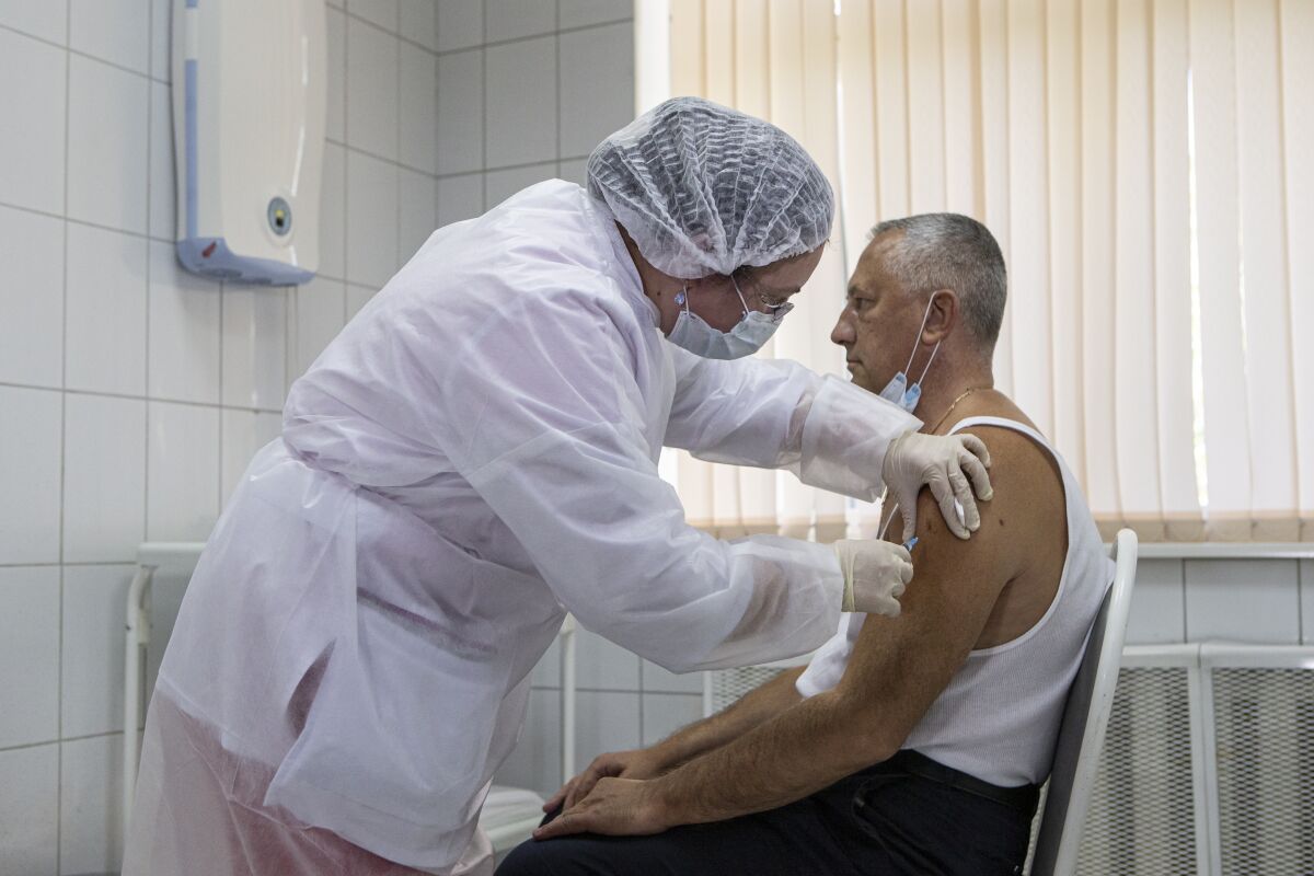 Russian medical worker administers a shot of Russia's experimental COVID-19 vaccine in Moscow.
