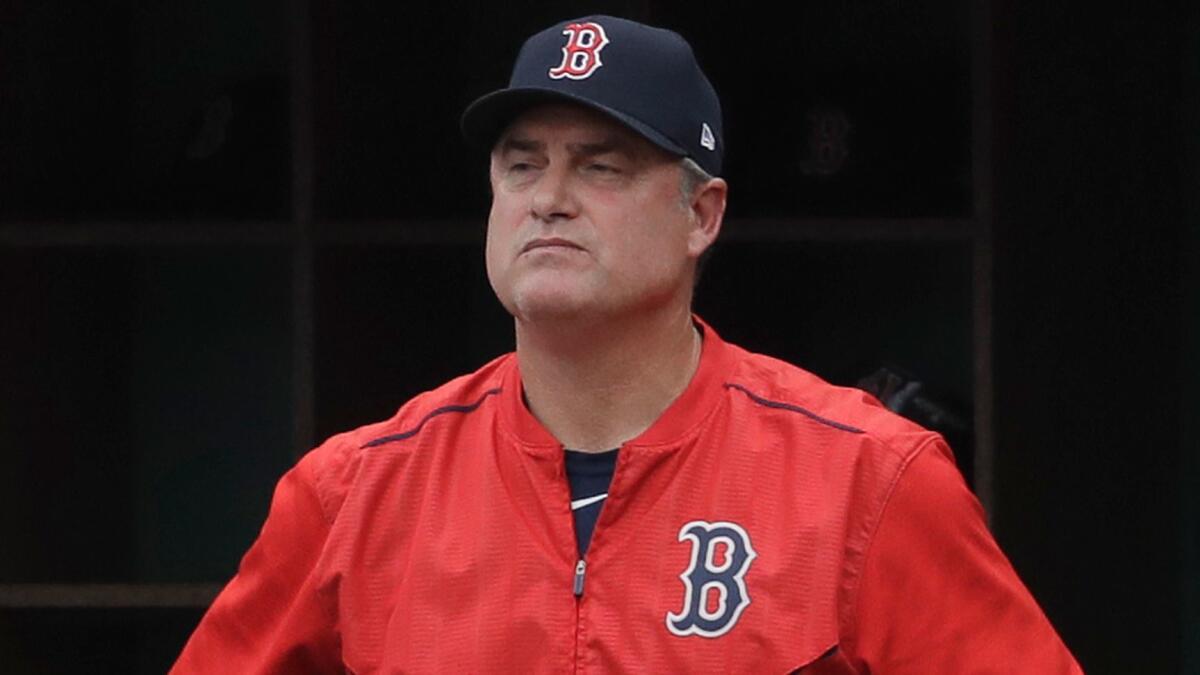John Farrell watches from the dugout as the Boston Red Sox play the Houston Astros in Game 3 of their American League Division Series on Oct. 8.
