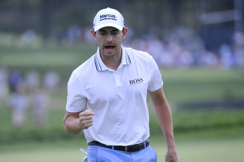 Patrick Cantlay reacts after sinking in his putt on the 18th green, the sixth playoff hole.