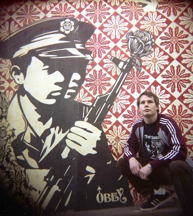 Street artist Shepard Fairey poses in front of a mural he painted on the side of Brooklyn Projects, an Echo Park skate shop.