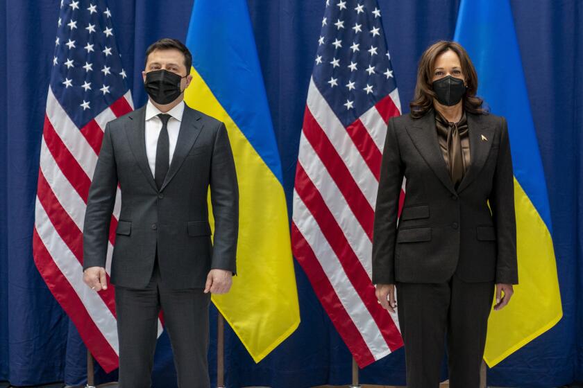 US Vice President Kamala Harris and Ukrainian President Volodymyr Zelenskyy pose for photographs before meeting during the Munich Security Conference, Saturday, Feb. 19, 2022, in Munich. (AP Photo/Andrew Harnik, Pool)