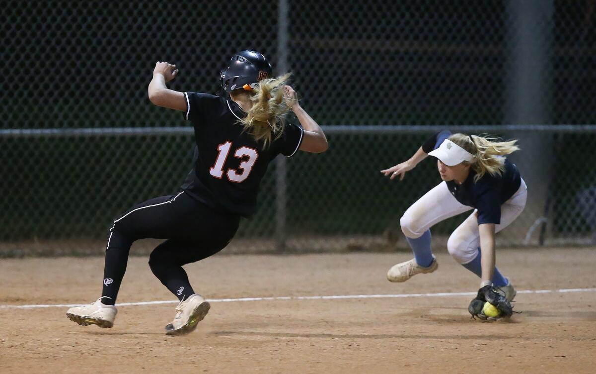 Huntington Beach High's Ameryn Humble (13) slides into third ahead of the tag by El Cajon Granite Hills' Erica Simon during the Michelle Carew Classic game at Peralta Canyon Park in Anaheim on Thursday.