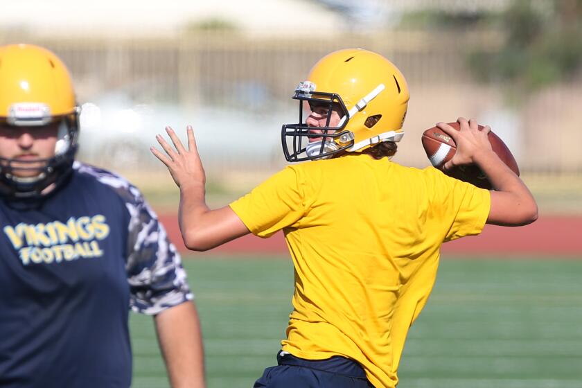 Quarterback Jack Miller throws a pass during practice at Marina High.