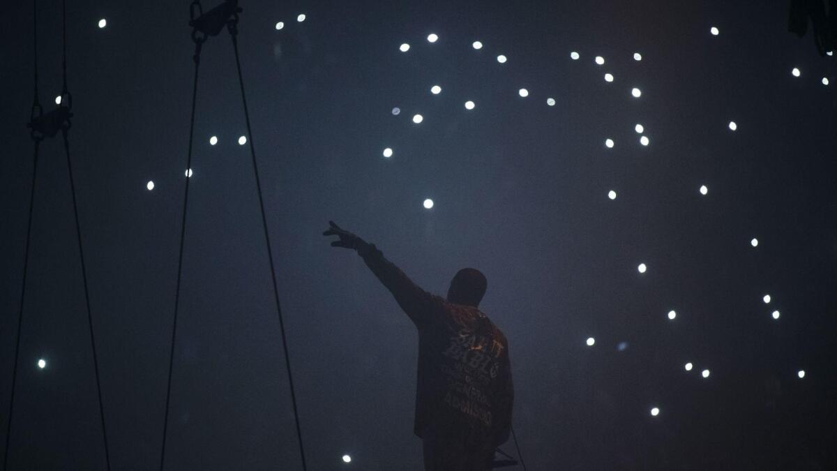 Kanye West was shrouded in shadows at the Forum.