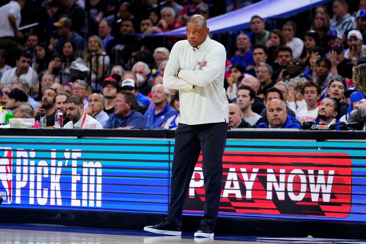 Doc Rivers has his arms folded across his chest as he watches from the sideline during a 76ers loss in the playoffs.