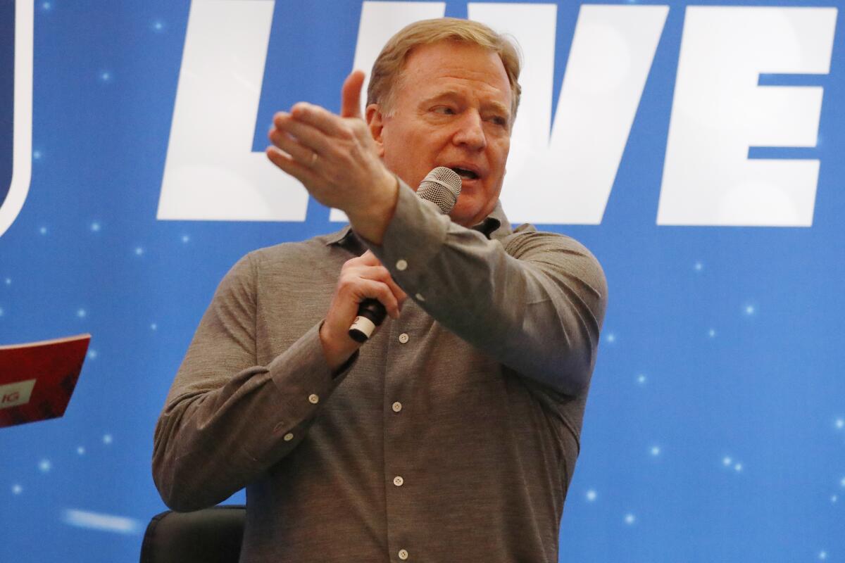 NFL commissioner Roger Goodell speaks on stage at a fan forum in London.