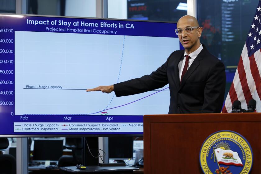 FILE - In this April 1, 2020, file photo Dr. Mark Ghaly, secretary of the California Health and Human Services, gestures to a chart showing the impact of the mandatory stay-at-home orders during a news conference on the state's response to the coronavirus, at the Governor's Office of Emergency Services in Rancho Cordova, Calif. Ghaly said Thursday, June 4, 2020, the state is staying in a "range of stability" on coronavirus cases and hospitalizations and has no plans to scale back its reopening efforts amid widespread protests that have brought people together in mass gatherings not seen in months. (AP Photo/Rich Pedroncelli, Pool, File)