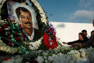 FILE - In this March 23, 2004 file photo, people place flowers at the base of a statue of Luis Donaldo Colosio during a ceremony marking the ten year anniversary of his assasination in Tijuana, Mexico. Mexico's national transparency agency has ordered on Wednesday, Oct. 31, 2018, prosecutors to release 13 video recordings related to the 1994 assassination of Colosio. (AP Photo/David Maung, File)