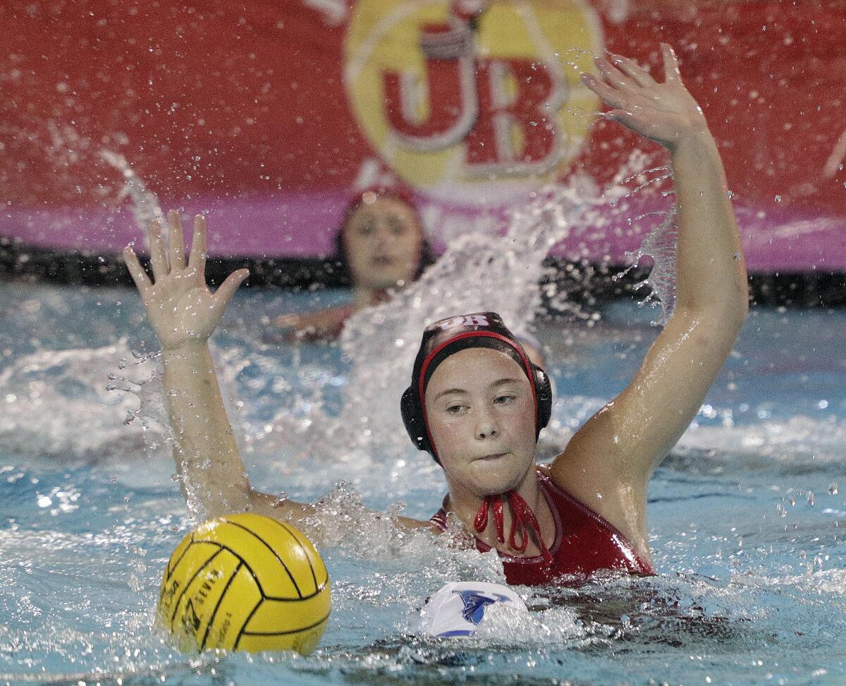 Burroughs' Charlotte Jennings defends against an entry pass by Santa Ana's Alice Rodriguez in the first round of the CIF Southern Section Division V girls' water polo playoffs at Burroughs High School on Tuesday, February 11, 2020. Burroughs won the game and advances.