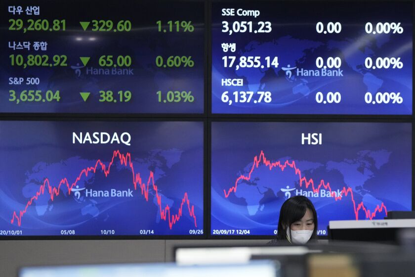 A currency trader watches monitors at the foreign exchange dealing room of the KEB Hana Bank headquarters in Seoul, South Korea, Tuesday, Sept. 27, 2022. Stocks were mixed in Asia on Tuesday after closing broadly lower on Wall Street, where the Dow Jones Industrial Average fell into what’s known as a bear market. (AP Photo/Ahn Young-joon)