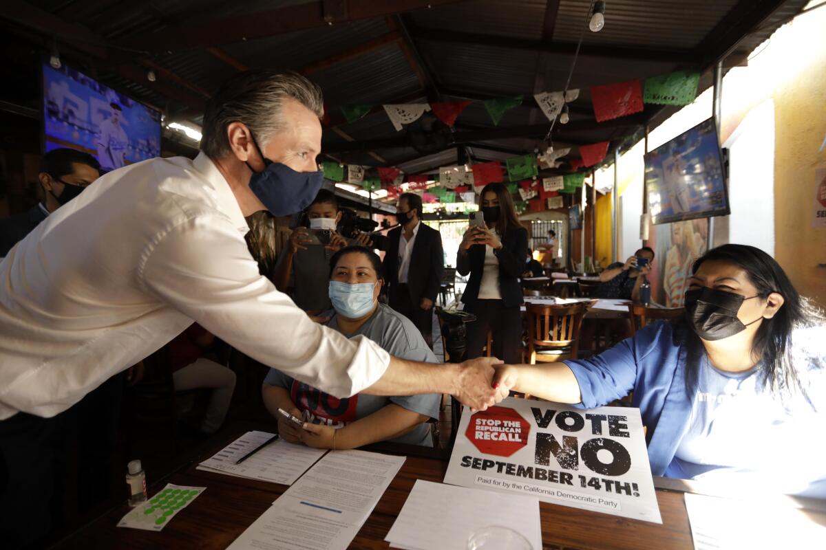Gov. Gavin Newsom greets campaign volunteers at Hecho en Mexico restaurant in El Sereno on Aug. 14. 