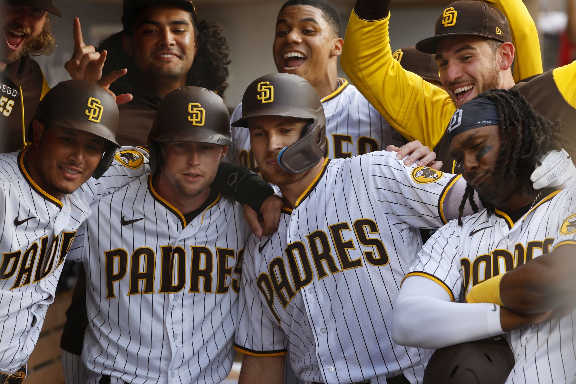 Padres players surround Brandon Drury, center, for a photo after he