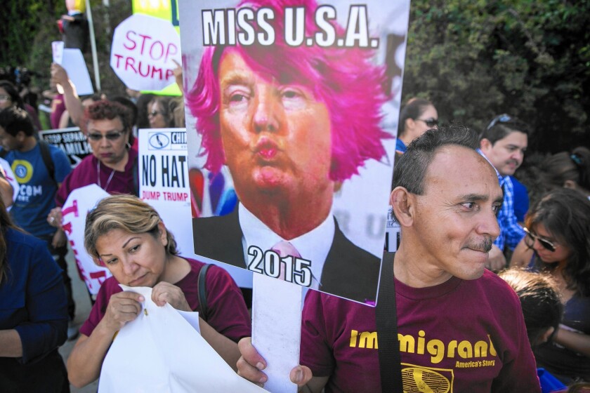 Supporters with the Coalition for Humane Immigrant Rights of Los Angeles gather outside the Luxe Sunset Boulevard Hotel in Bel-Air on Friday evening to protest GOP presidential candidate Donald Trump.