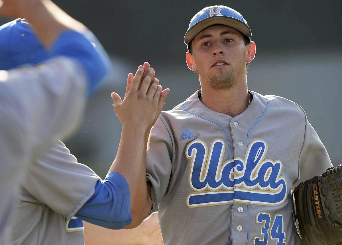 UCLA starting pitcher Cody Poteet is greeted by teammates after the sixth inning Sunday afternoon in a victory over Cal State Bakersfield.
