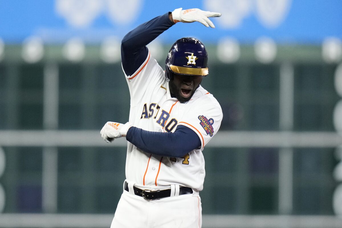 Houston Astros' Yordan Alvarez reacts after hitting a three-run double during the seventh inning of a baseball game against the Chicago White Sox, Friday, March 31, 2023, in Houston. (AP Photo/Eric Christian Smith)