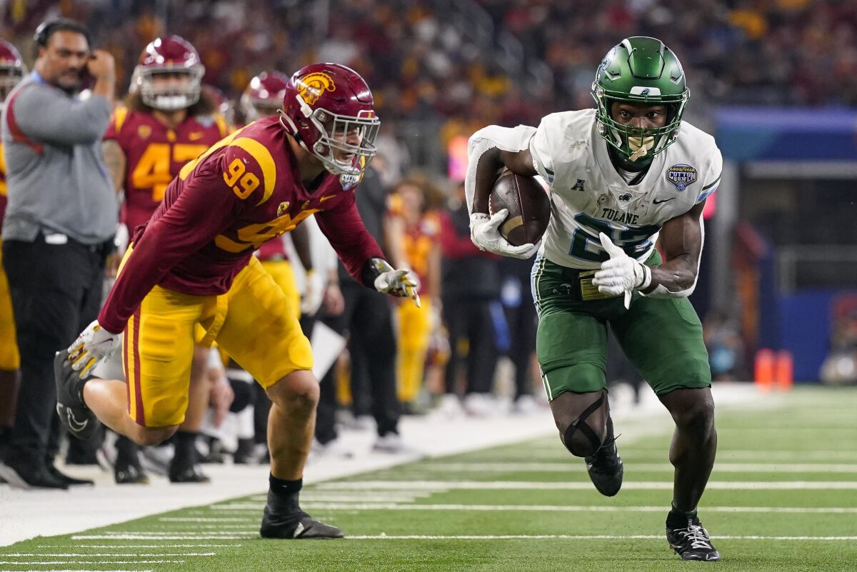 Tulane running back Tyjae Spears runs with the ball as USC defensive lineman Nick Figueroa defends.