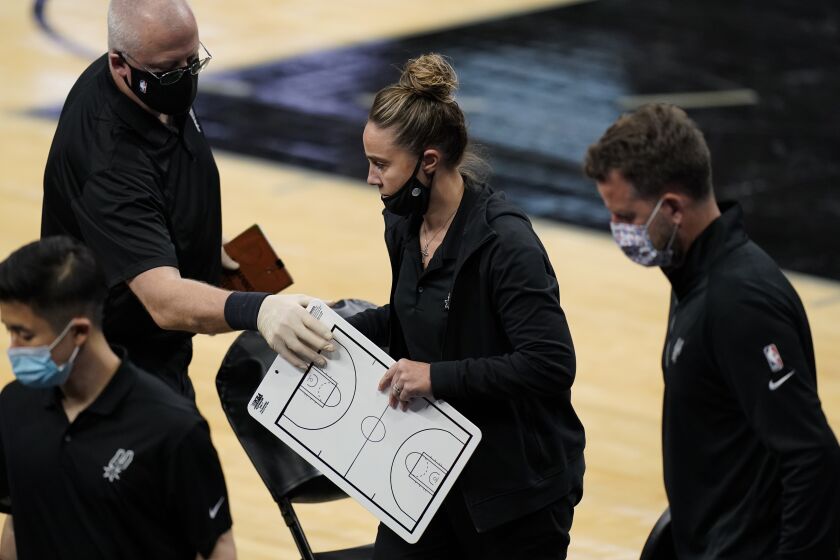 San Antonio Spurs assistant coach Becky Hammon, center, during a timeout in the second half of an NBA basketball game against the Los Angeles Lakers after head coach Gregg Popovich was ejected from the game, in San Antonio, Wednesday, Dec. 30, 2020. (AP Photo/Eric Gay)