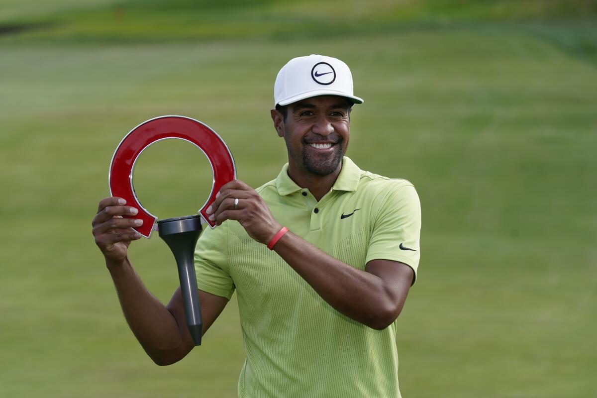 Tony Finau holds the winner's trophy after the final round of the Rocket Mortgage Classic.