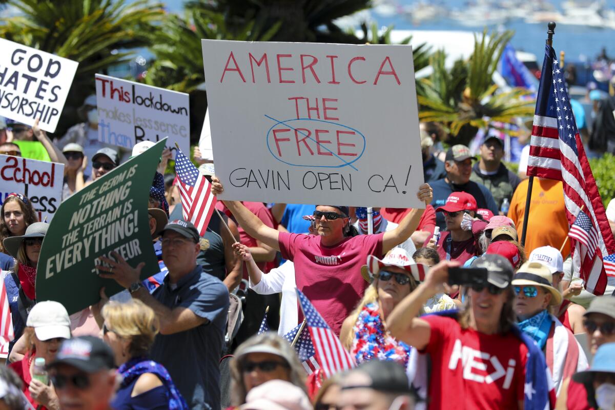 Demonstrators gathered at a noon rally in front of the San Diego County administration building on Saturday to demand that elected leaders open California.