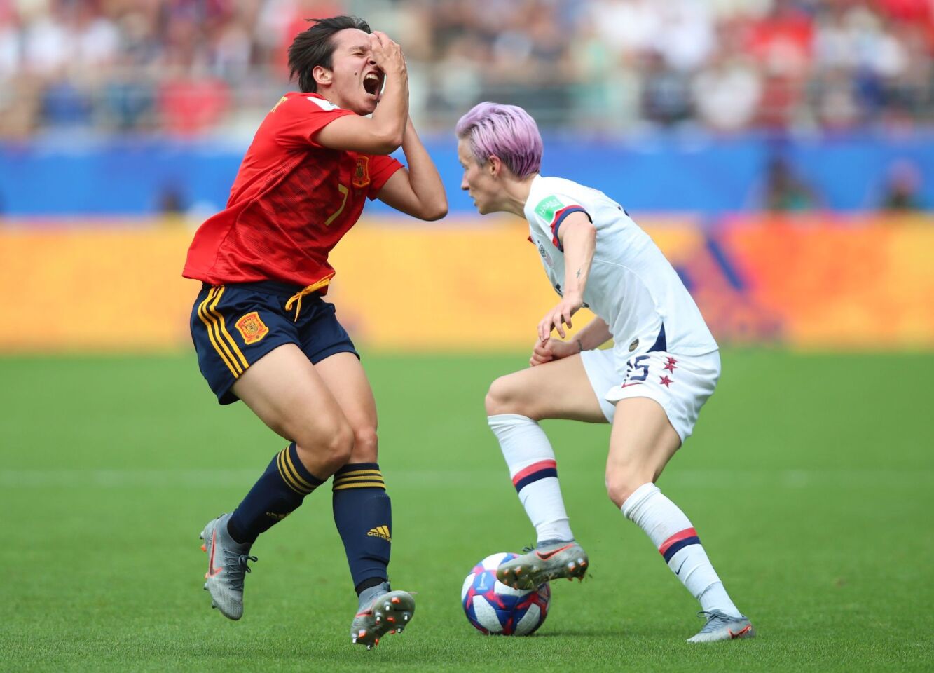 Mandatory Credit: Photo by TOLGA BOZOGLU/EPA-EFE/REX (10320464ag) Megan Rapinoe (R) of USA in action against Marta Corredera (L) of Spain during the FIFA Women's World Cup 2019 round of 16 soccer match between Spain and USA at Reims, France, 24 June 2019. FIFA Women's World Cup 2019, Reims, France - 24 Jun 2019 ** Usable by LA, CT and MoD ONLY **