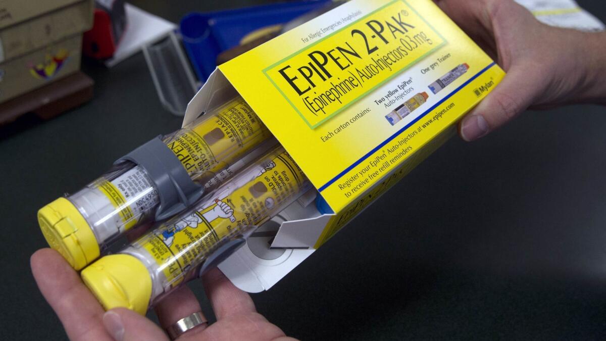 A pharmacist holds a package of EpiPens from Mylan. The first generic version of EpiPen, from Teva Pharmaceuticals USA, has been approved by the Food and Drug Administration.