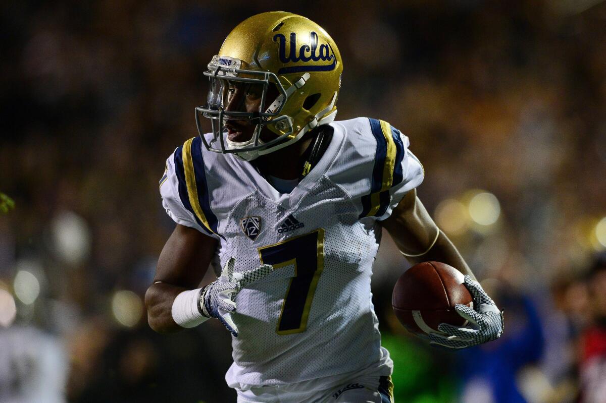 UCLA wide receiver Darren Andrews (7) runs for a touchdown in the first quarter against the Colorado Buffaloes on Nov. 3.