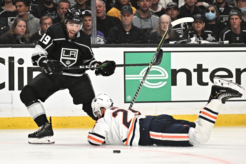 Los Angeles, California May 8, 2022-Kings Alex Iafallo battle for the puck with Oilers Darnell Nurse in the third period in Game four of the of the Stanley Cup first round playoffs at Crypto.com Arena Sunday. (Wally Skalij/Los Angeles Times)