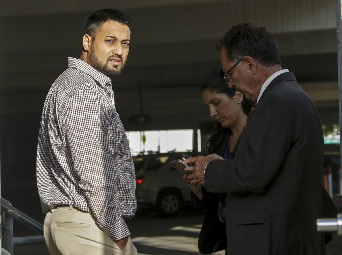 Syed Raheel Farook, left, is released on bail at the Riverside Federal Courthouse in April 2016. He and wife, Tatiana Farook, have pleaded guilty to charges of conspiracy to commit immigration fraud related to a sham marriage.