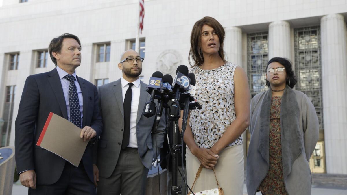 Zhoie Perez, second from right, speaks during a news conference in downtown Los Angeles.