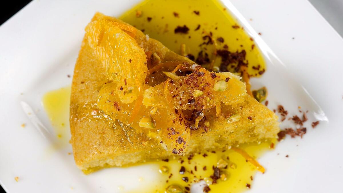 Orange and olive oil semolina cake with pistachios, chocolate and olio nuovo.