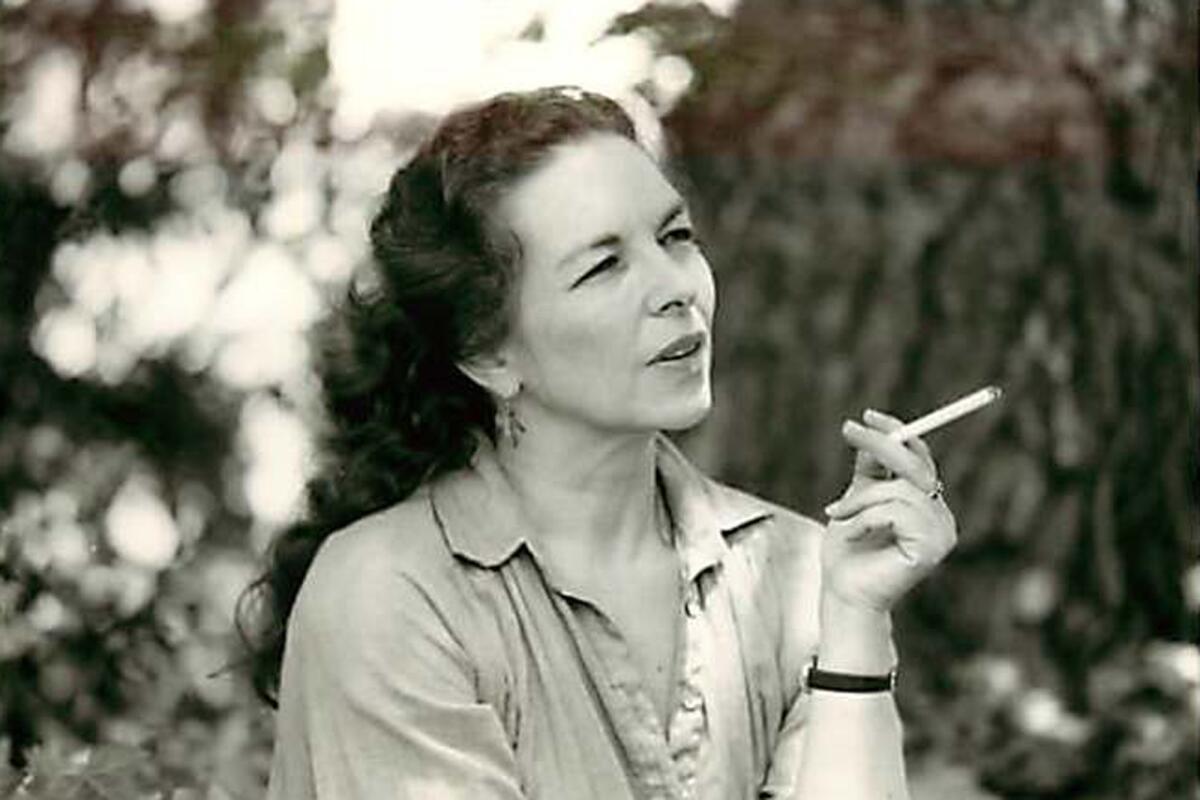 A woman smokes a cigarette outdoors