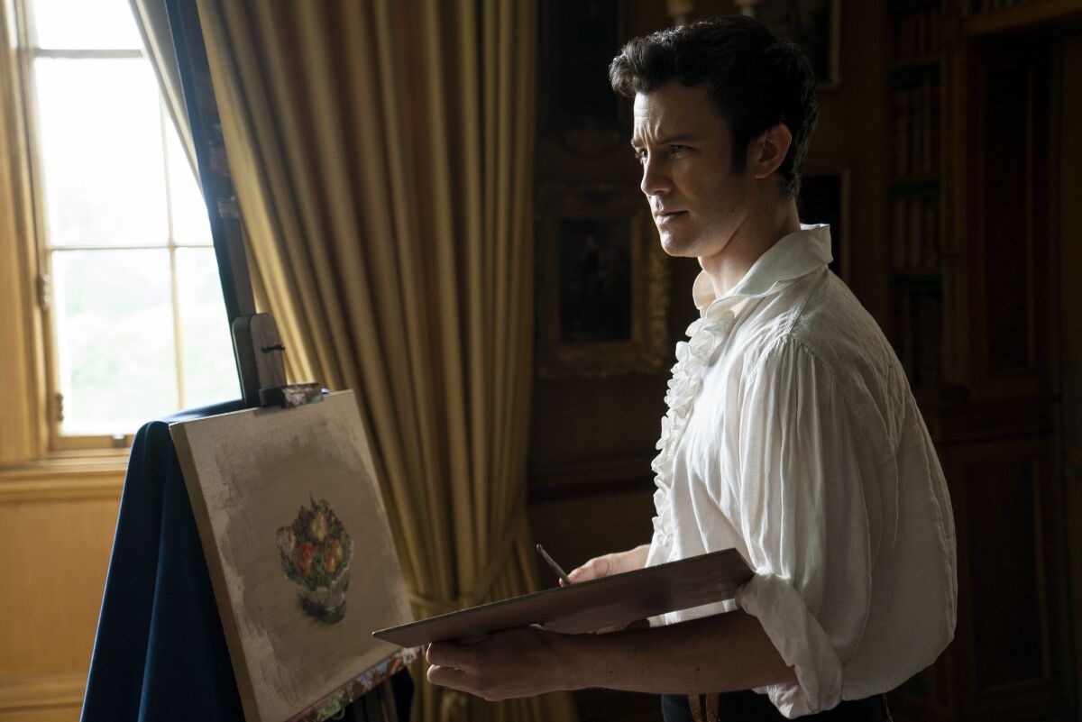 A man in a white shirt painting