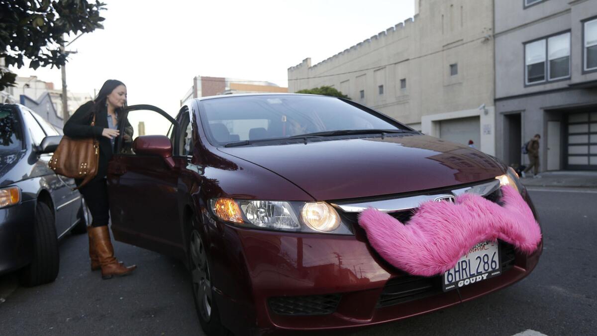 A Lyft passenger gets into a car in San Francisco.