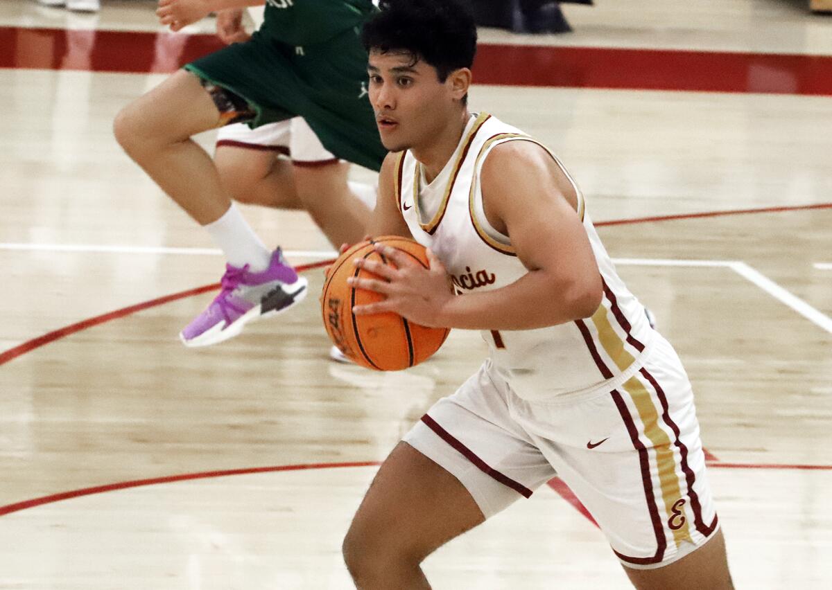 Estancia's Peter Sanchez (44) passes during a fast break against Costa Mesa on Friday night.