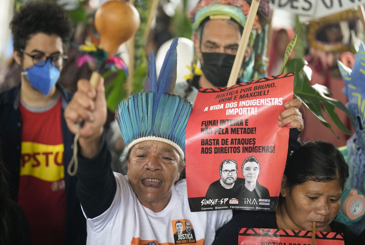 Guarani Indigenous and human rights activists rally in support of British journalist Dom Phillips and Indigenous expert Bruno Perreira, demanding authorities conduct a thorough investigation into the circumstances leading to their deaths, and do more to protect indigenous lands against illegal miners, loggers, and fishermen, in Sao Paulo, Brazil, Saturday, June 18, 2022. (AP Photo/Andre Penner)