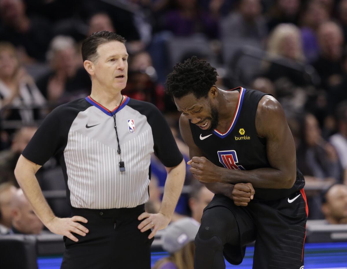 Los Angeles Clippers guard Patrick Beverley, right, reacts as he discusses the foul called on him by referee Pat Fraher during the second half of the team's NBA basketball game against the Sacramento Kings in Sacramento, Calif., Friday, March 1, 2019. The Clippers won 116-109.