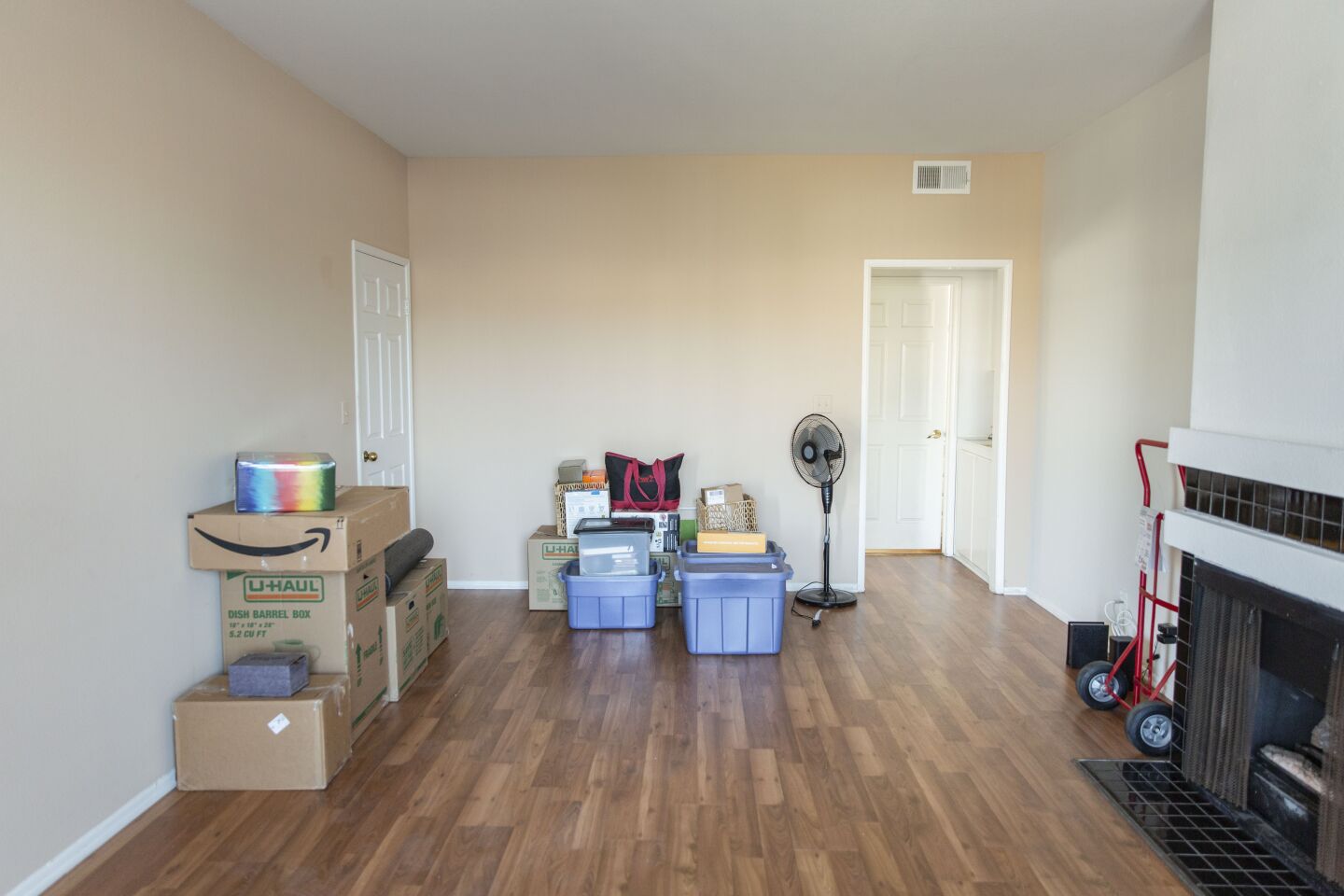 Dillon’s items are stacked in his new living room in Palms. The apartment has a gas fireplace.