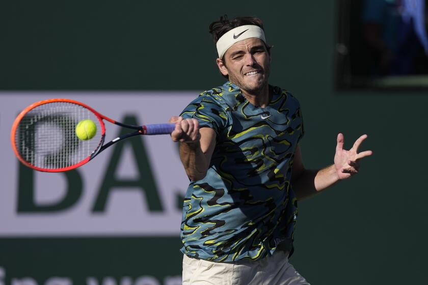 Taylor Fritz returns to Sebastian Baez, of Argentina, at the BNP Paribas Open.