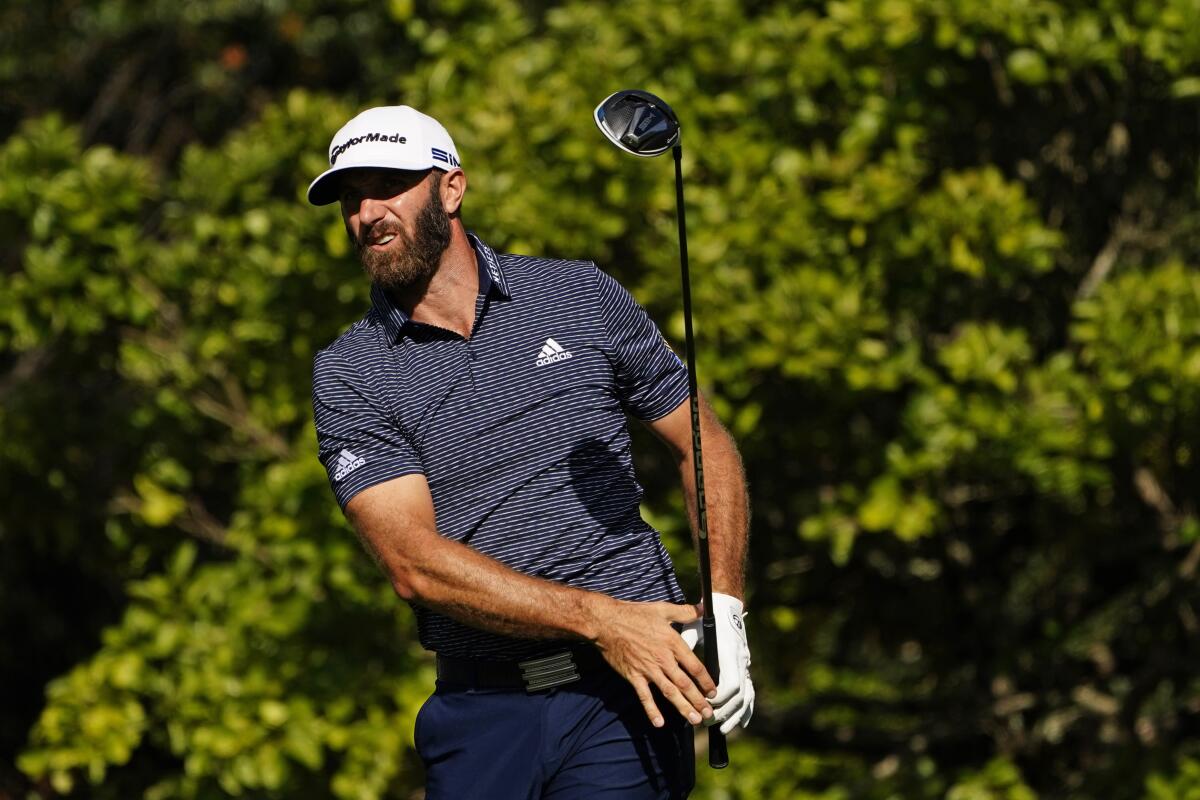 Dustin Johnson watches his drive on the fifth tee during the final round of the Masters golf tournament.