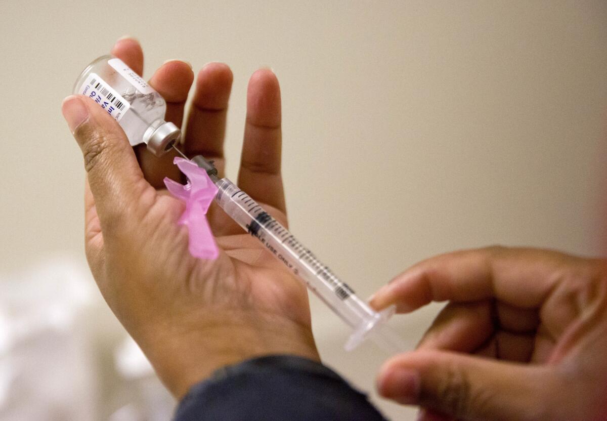 A nurse prepares a flu shot in Atlanta in February 2018. The U.S. winter flu season is off to its earliest start in more than 15 years.