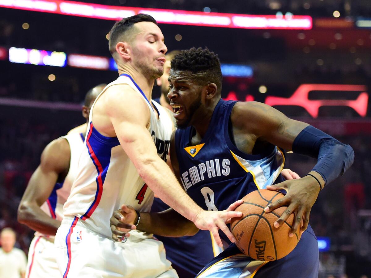 Clippers shooting guard J.J. Redick blocks the path of the Grizzlies' James Ennis (8) as he drives to the basket during the first half on Nov. 16.