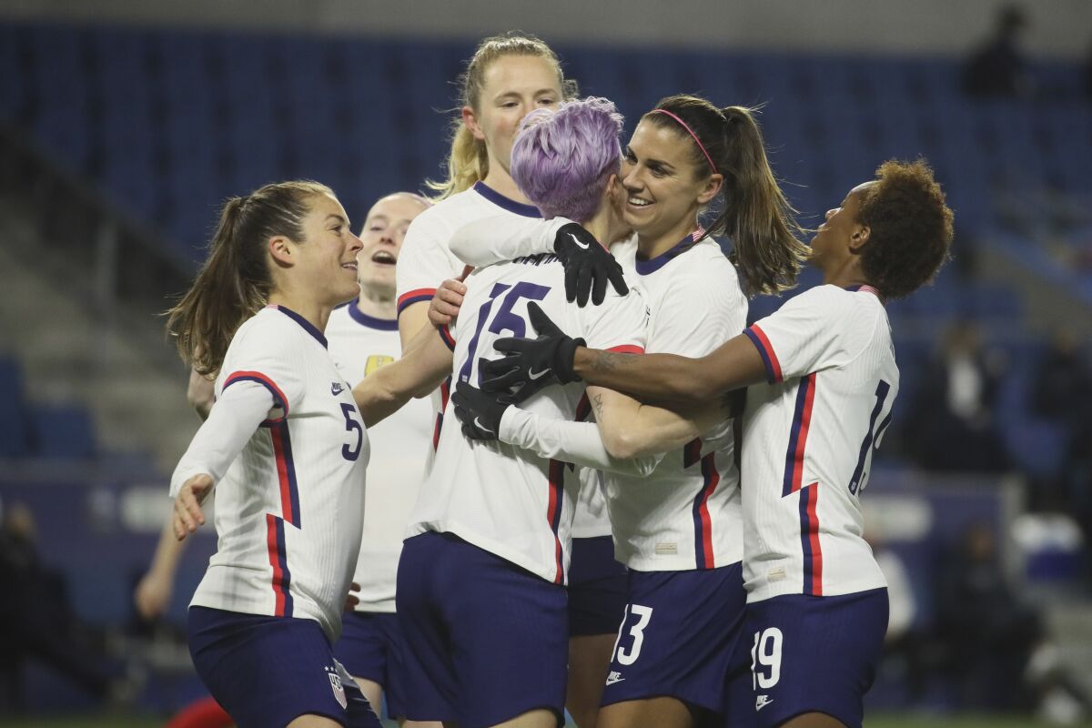 United States' Megan Rapinoe (15) is congratulated by teammates after scoring on a penalty kick 