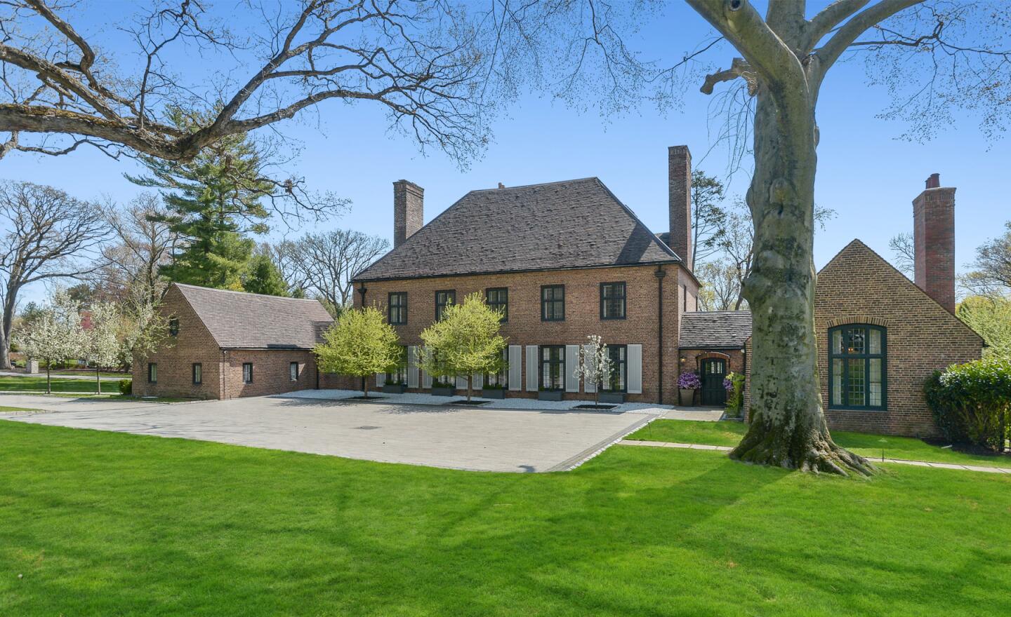 The 2.6-acre spread centers on a 1920s English manor with antique accents and an attic with a wet bar.