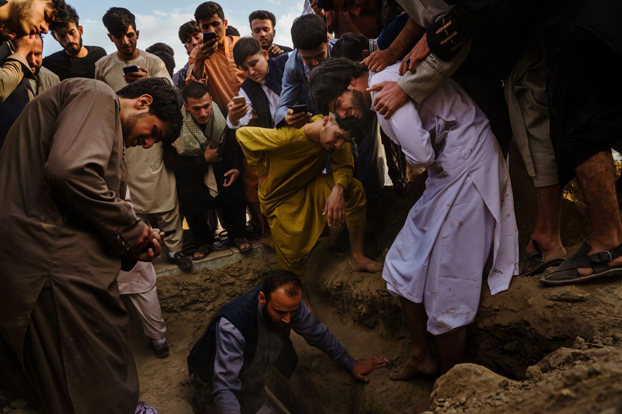 Relatives weep as they bury Nasser Ahmadi, whose family said was killed in a U.S. drone airstrike.