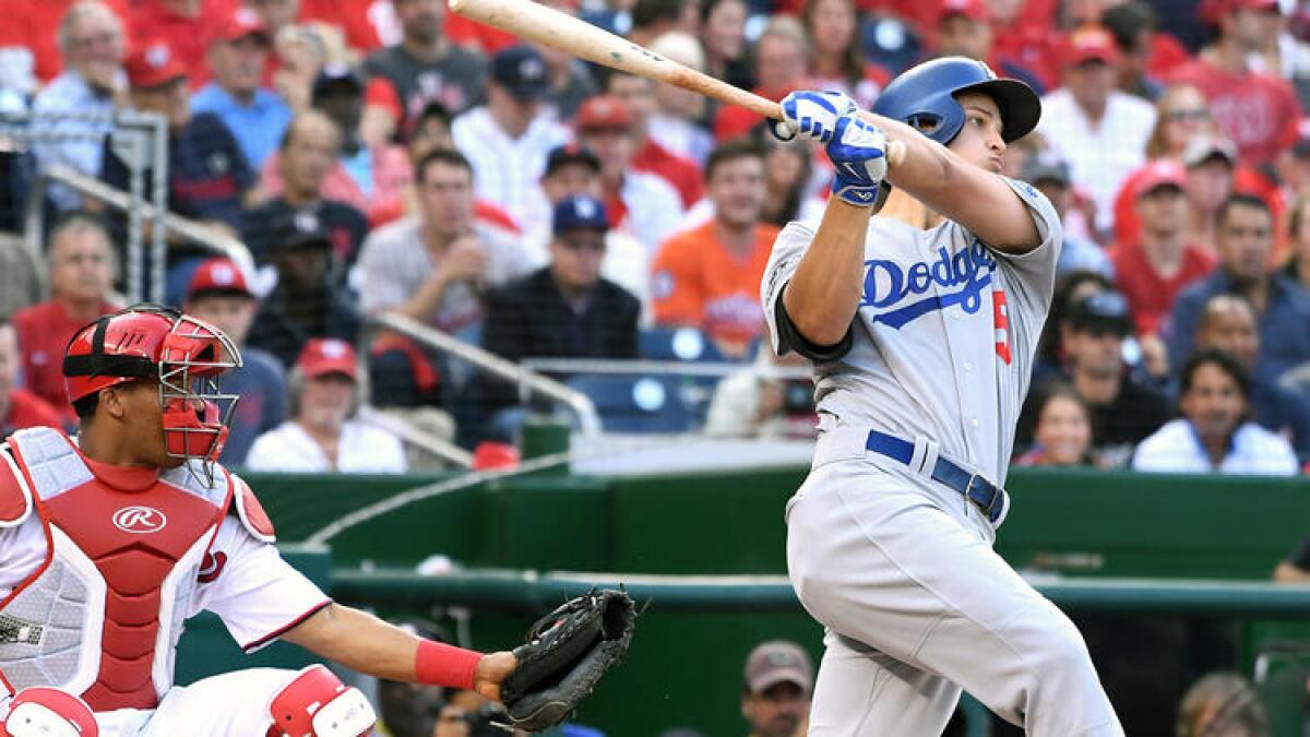 Dodgers shortstop Corey Seager follows through after hitting a solo home run. To see more images from Game 1, click on the photo above.