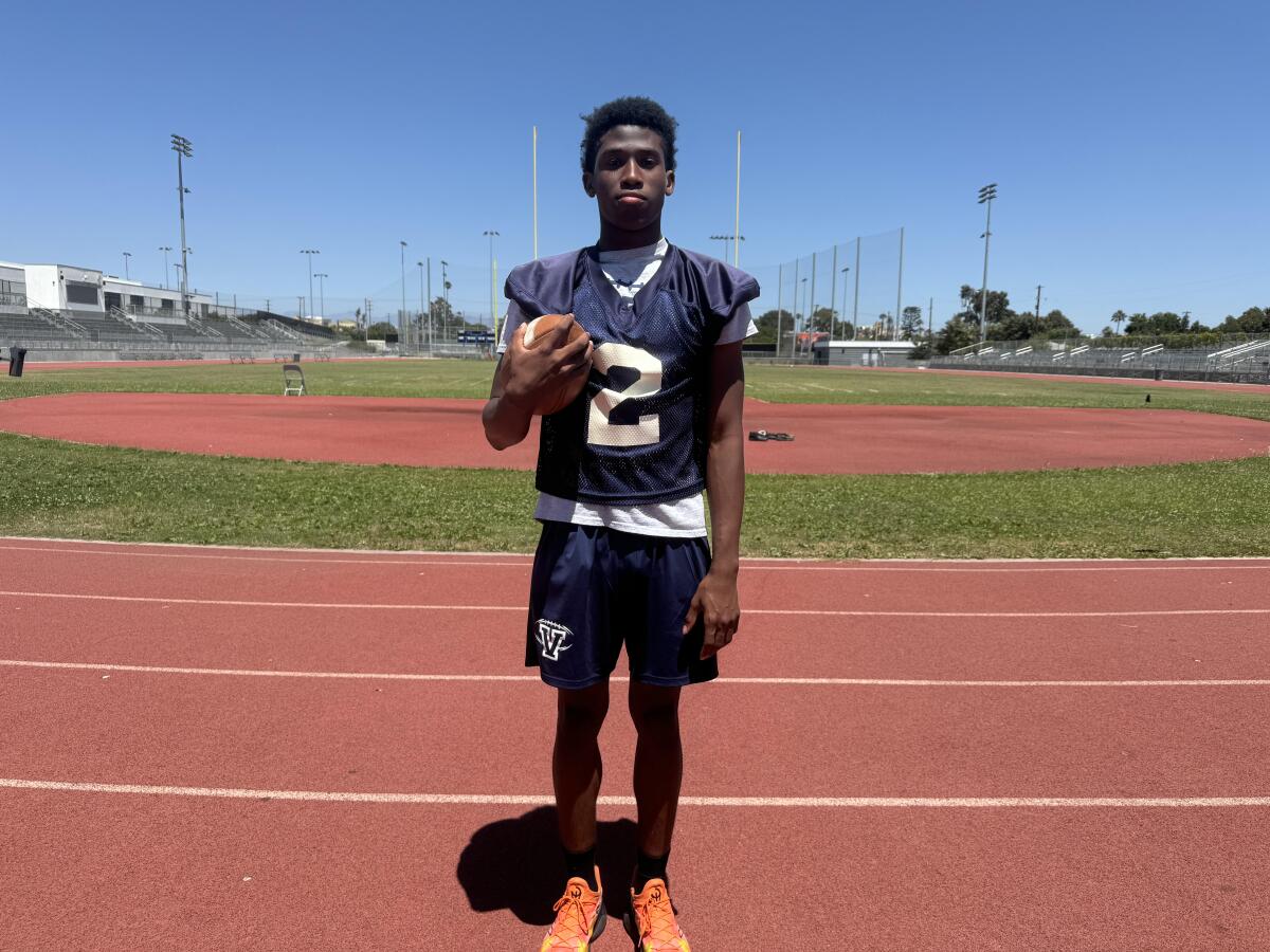 Nathan Santa Cruz of Venice, holding a football, began practice Monday as a 16-year-old senior.