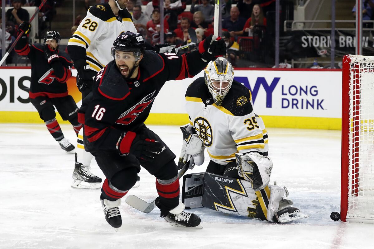 Carolina Hurricanes' Vincent Trocheck (16) celebrates a goal by Sebastian Aho, not seen, on Boston Bruins goaltender Linus Ullmark (35) during the second period of Game 2 of an NHL hockey Stanley Cup first-round playoff series in Raleigh, N.C., Wednesday, May 4, 2022. (AP Photo/Karl B DeBlaker)