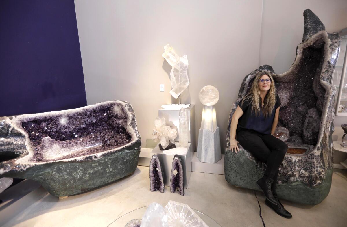 Cheryl Rey, curator and manager of Crystalarium, sits on a one-ton amethyst throne.
