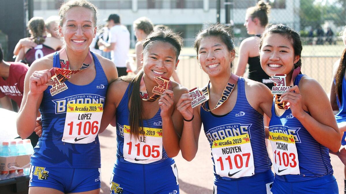 Sophie Lopez, Amie Le, Crystal Nguyen, and Kaho Cichon hold up their championship medals at the Arcadia Invitational at Arcadia High School on Saturday, April 6, 2019.